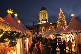 night view of a market with tents, lights, stars, vendors