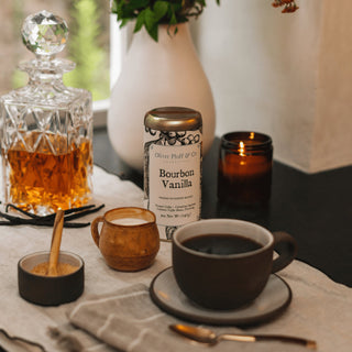 bourbon vanilla coffee tin on tabletop with brewed mug of coffee
