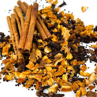 close up view of cinnamon sticks and loose leaf tea sprinkled