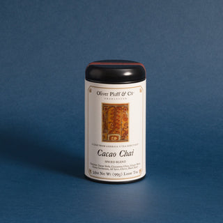 black tea tin with orange rectangle on label against blue backdrop
