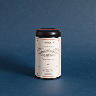 black tea tin with OP logo against a blue background