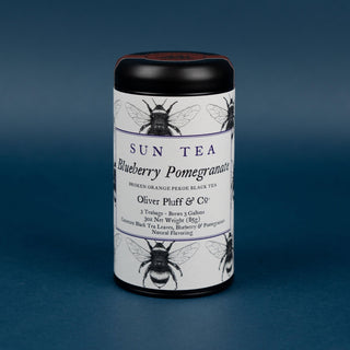blueberry pomegranate sun tea tin on blue background