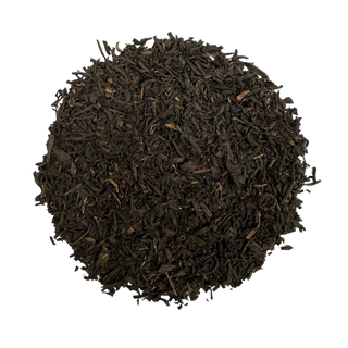 Close-up of dark brown tea leaves on a white background