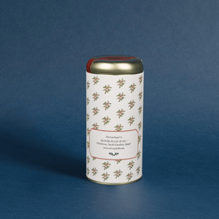 Cylindrical coffee canister with decorative label on a blue background