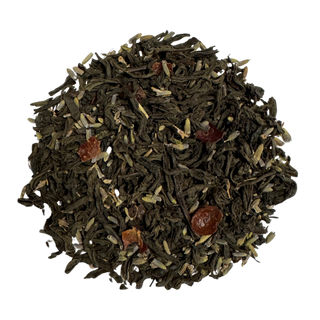 Tea leaves with lavender blossoms and rose hips on a white background