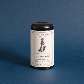 black tea tin with white label on blue background