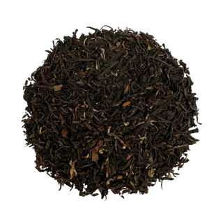 Pile of black tea leaves on a white background