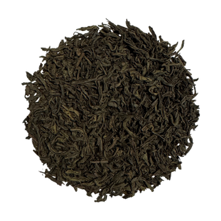 Round pile of dark brown tea leaves on a white background