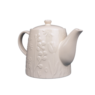 white teapot with raised floral design on white background