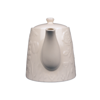 white teapot with raised floral design on white background