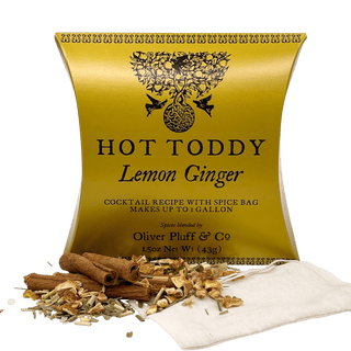 shiny yellow tea pouch with cinnamon sticks and dried tea leaves sprinkled in front
