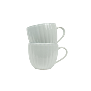 Two white ceramic mugs stacked on a white background