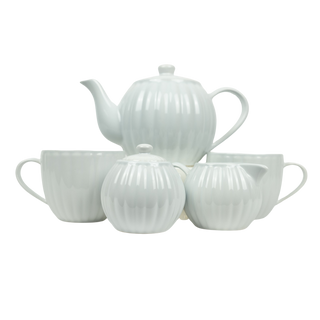 White ceramic teapot and cups set on a white background