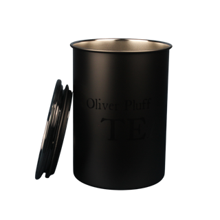 Black cylindrical container with silver interior and 'Oliver Pluff' branding on a white background