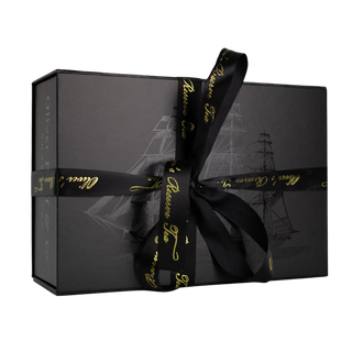 gift box with black ribbon and gold writing