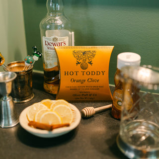 orange clove pillow box on bar with lemons