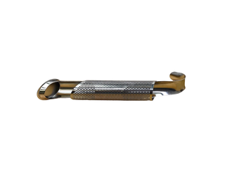 stainless steel tea infuser pipe with tea in it and mug in the background