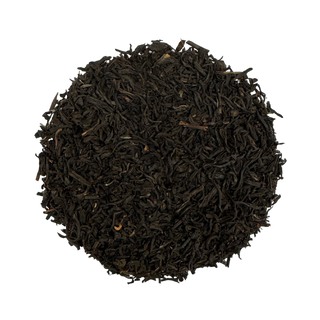 Close-up of black tea leaves on a white background