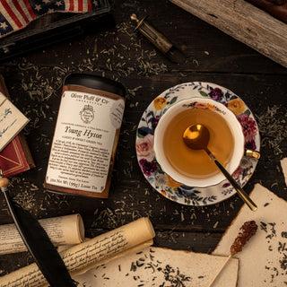 young hyson loose tea tin with cup of brewed tea