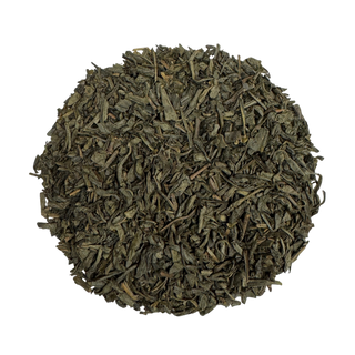 Dry green tea leaves on a white background