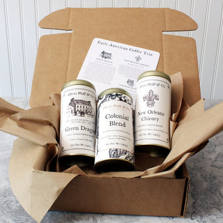 opened brown packaging box with three gold tea tins and instructions
