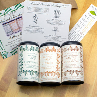 set of three tea tins on wood tabletop