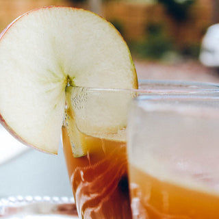 photo of fresh apple slice on cold glass of tea