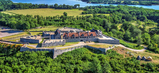 an aerial view of fort ticonderoga during the day, surrounded by trees with a lake in the background