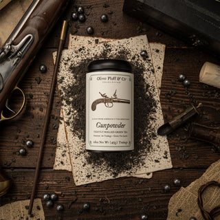 gunpowder tea tin surrounded by black powder rifle accessories