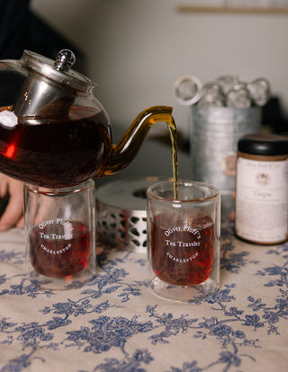 in-store image of oliver pluff's tea shop showing a table covered in teapots and teaware