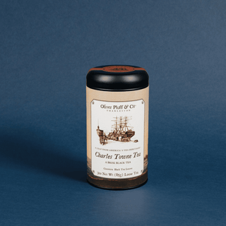 tea tin on blue background that reads 'charles towne tea' with sketch ship design
