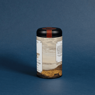 Tea canister with a decorative label on a blue background