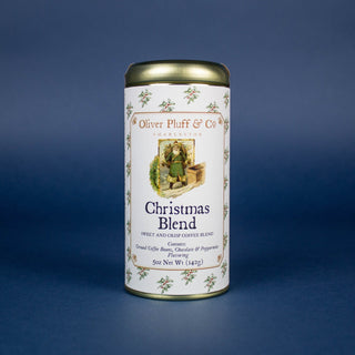 A gold coffee tin with image of Santa Clause and seasonal greenery label