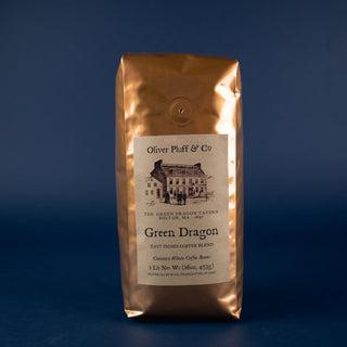 shiny gold coffee bag with old timey house graphic on label for whole bean coffee