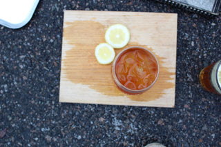 iced tea with sliced lemons on a cutting board