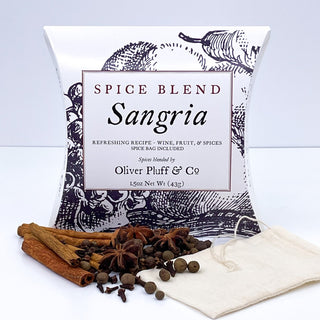 black and white tea pouch with cinnamon sticks, cloves, allspice, star anise and a tea bag scattered in front 