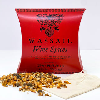 red tea pouch with Orange Peel, Ginger, Cinnamon, Allspice, Cloves sprinkled in front and white teabag on counter