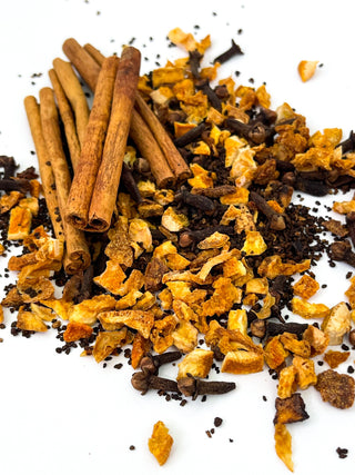 close up view of cinnamon sticks and loose leaf tea sprinkled 