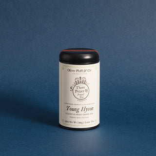  4oz loose tea, sealed in matte black signature tea tin against blue background