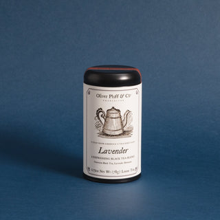 black tea tin with old timey graphic of a teapot, against blue background