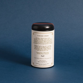 black tea tin with typed history on backside against a blue backdrop 