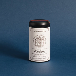 black tea tin with photo from early america people and blue backdrop 