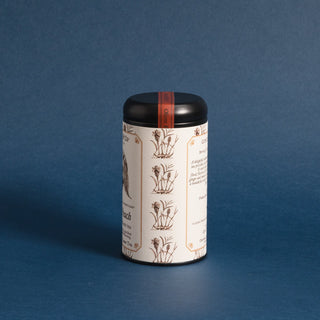 side view of black tea tin with black and white peach graphic