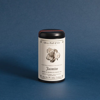 black tea tin with black and white flower on label