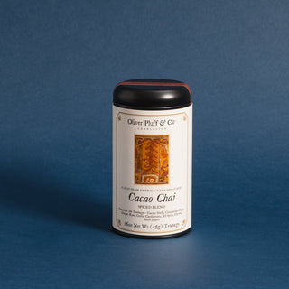 black tea tin with orange rectangle on label against a blue backdrop