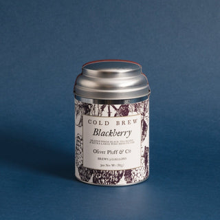 silver tea tin with blackberry graphics and blue backdrop