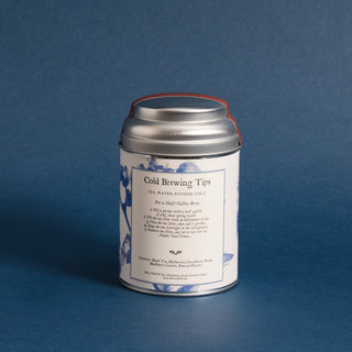 brewing instructions on backside of silver tea tin with blueberry graphics and blue backdrop