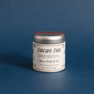 small silver tea tin with Oliver Pluff logo against a blue backdrop