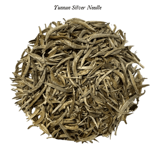 loose white tea leaves in round pile on clear background