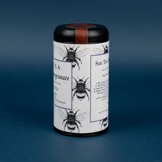 side of blueberry pomegranate sun tea tin on blue background